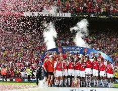 A high-action shot of Arsenal players celebrating on the pitch with the Premier League trophy