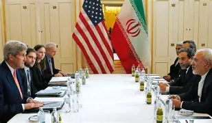 A split image showing the U.S. and Iranian flags with a diplomatic meeting